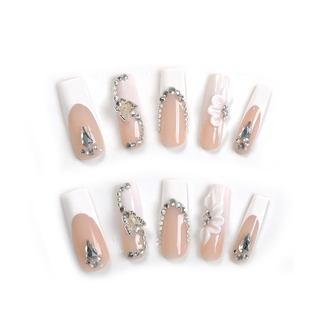 Kunstnagelset mit eleganten Glitzer- und Blütenmotiven Karnz