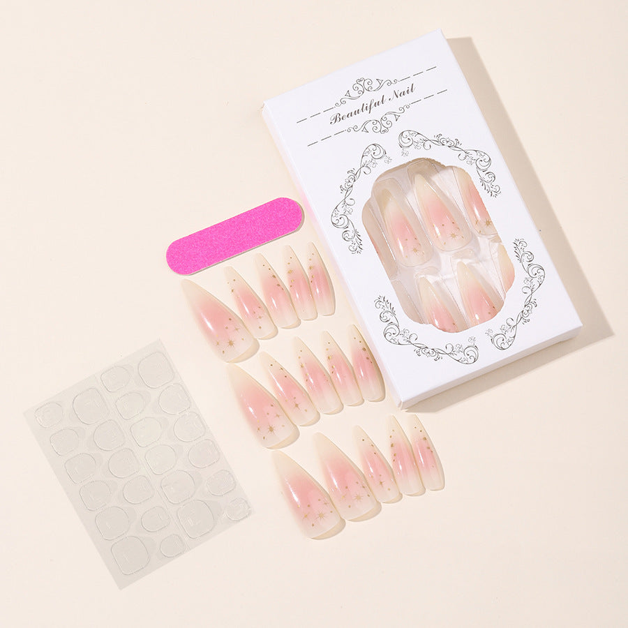 Kunstnagelset mit zartem Ombre-Design und glamourösen Sternakzenten Karnz