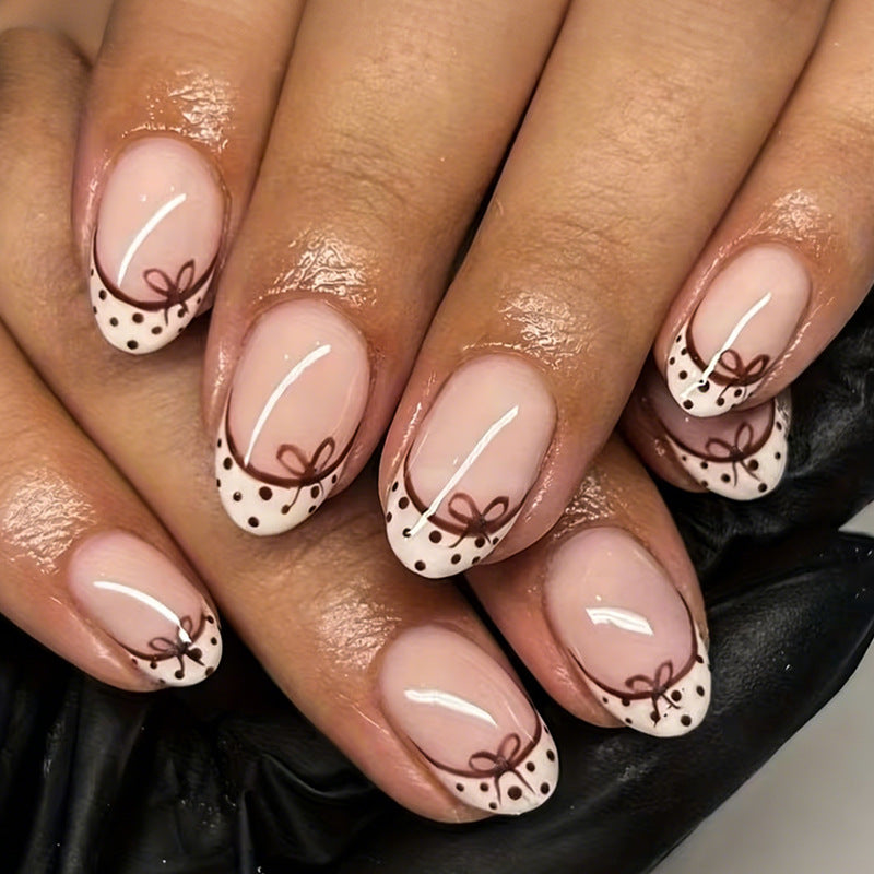 Kunstnagelset mit eleganten Schleifen- und Punktmotiven Karnz