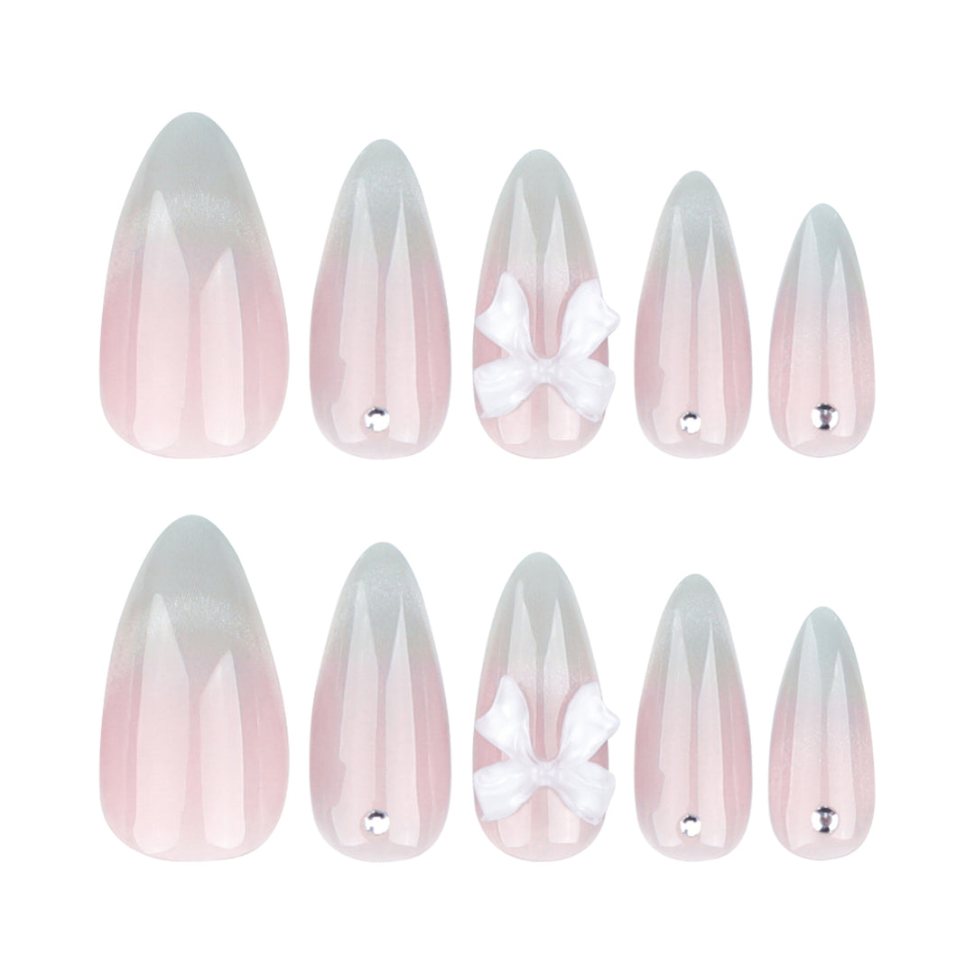 Elegante Stiletto-Nägel mit Glitzer- und Schleifenakzenten Karnz