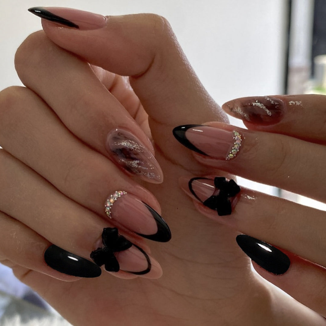 Künstlerische Stiletto-Nagelkunstverlängerungen mit Schleifenakzenten Karnz