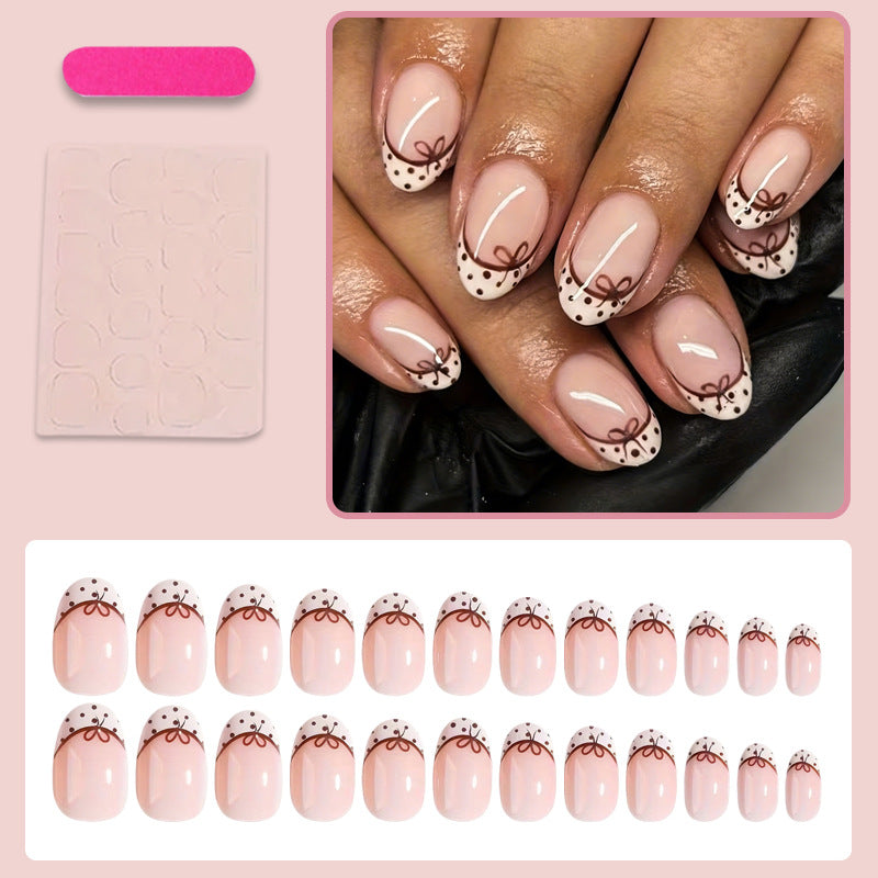 Kunstnagelset mit eleganten Schleifen- und Punktmotiven Karnz