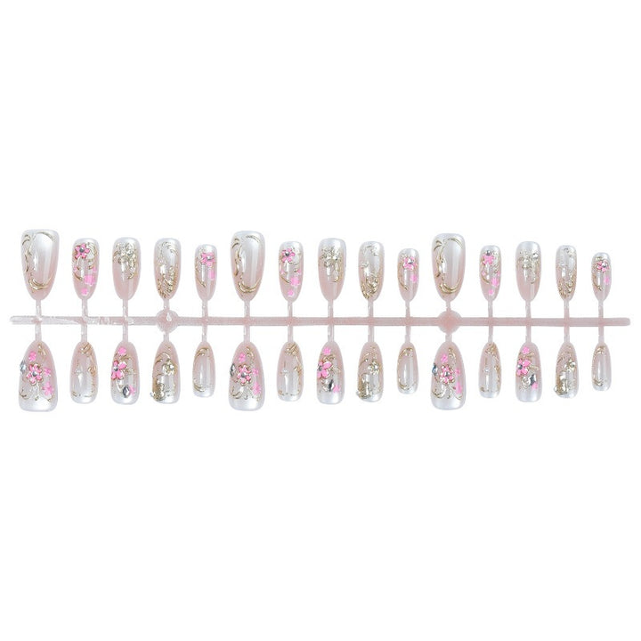 Glitzernde Kunstnägel mit floralem Design Karnz