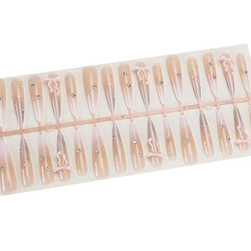 Elegante Stiletto Press-On Nägel mit dekorativem Bogen und Strassakzenten Karnz
