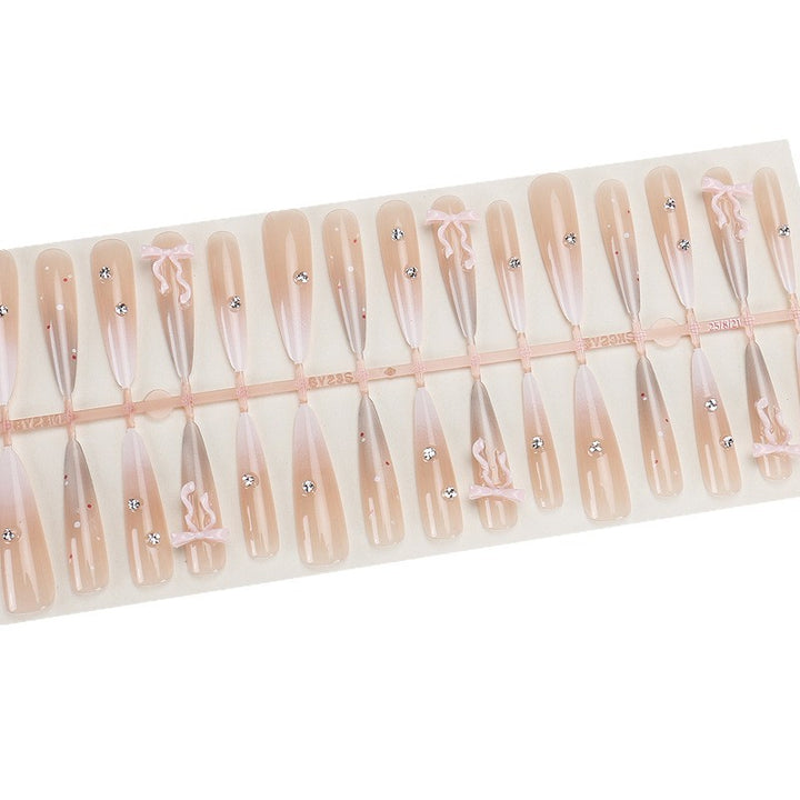 Elegante Stiletto Press-On Nägel mit dekorativem Bogen und Strassakzenten Karnz