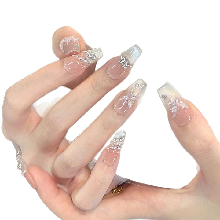 Dekorative Lange Stiletto Press-On Nägel mit Herz- und Blumenakzenten Karnz