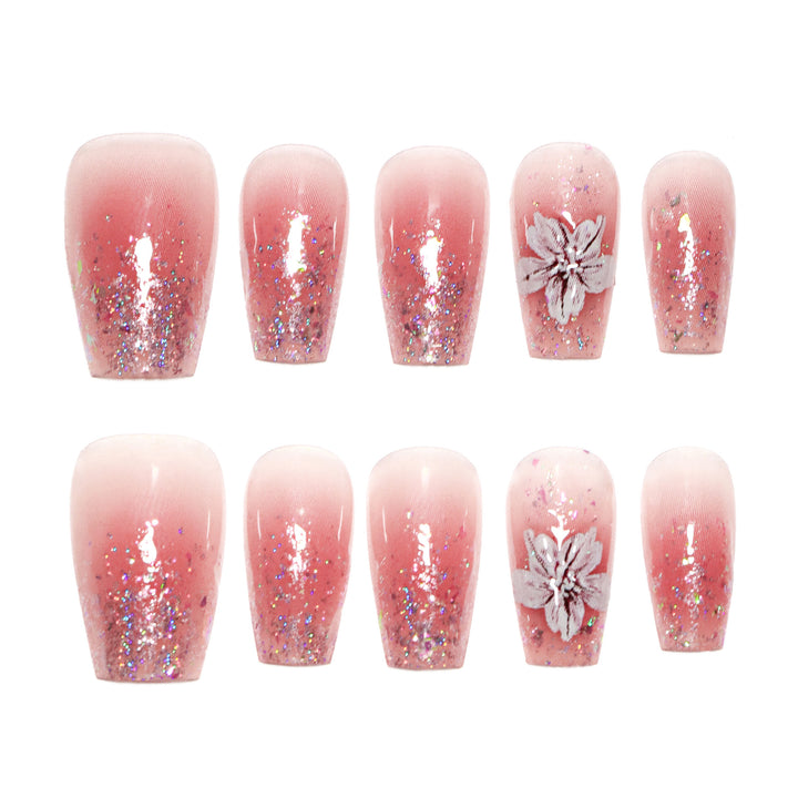 Künstliche Nagelverlängerungen mit floralem Design und Glitzerakzenten Karnz
