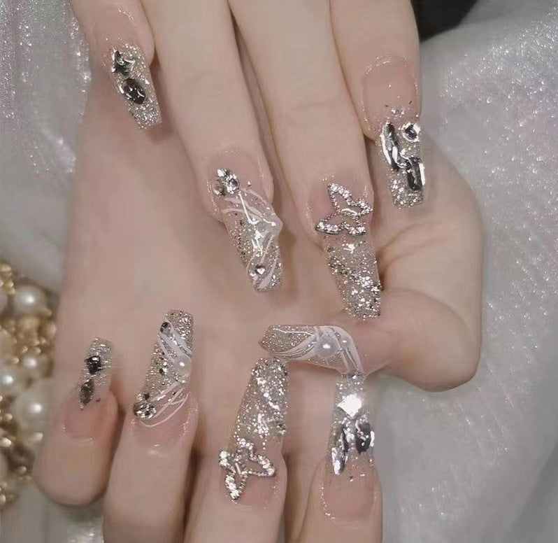 Kunstvolle Nagelkunst mit Glitzer- und Blumenapplikationen Karnz