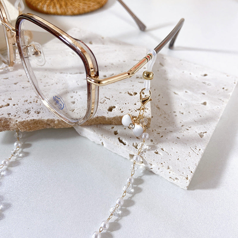 Elegante Ohrringe mit Perlen und Blütenanhängern Karnz