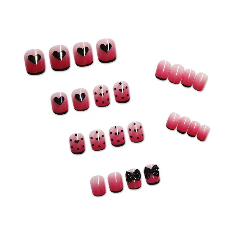 Themen Press-On Nagelset mit dekorativen Herz- und Schleifendesigns