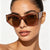 Damen kreative Cat-Eye Sonnenbrille mit transparentem Rahmen und braunen Gläsern Karnz