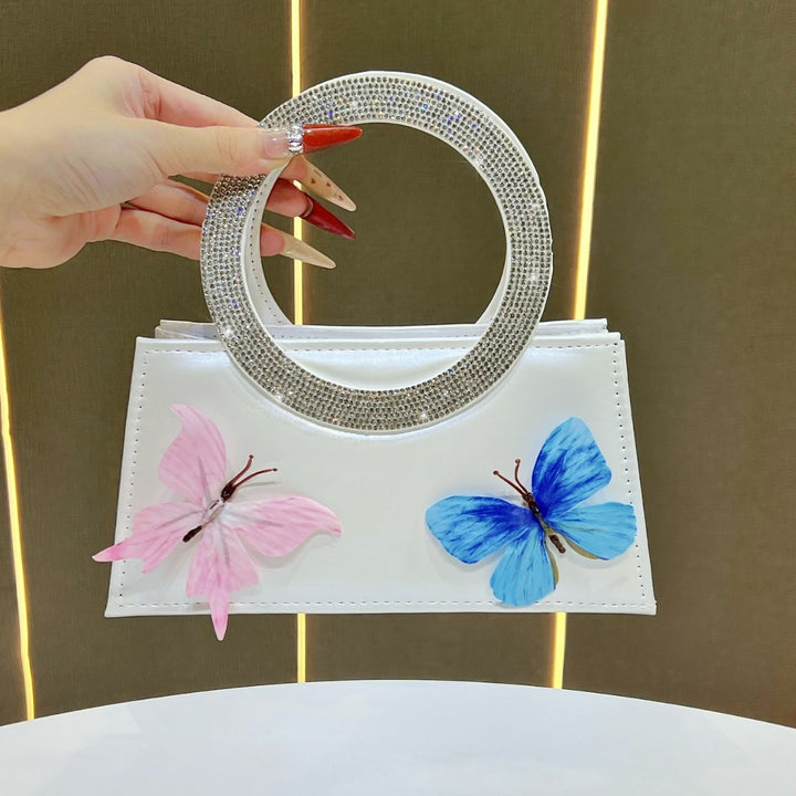 Künstlerische mit Schmetterlingen verzierte Handtasche