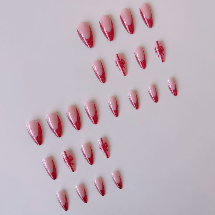 Kunstnagelset mit glamourösen Glitzer-Akzenten und Schleifen-Design Karnz