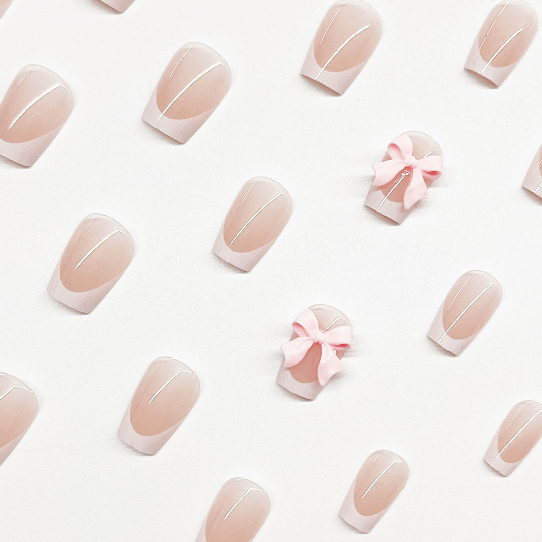 Dekorative French Tip Nagelverlängerungen mit Schleifenakzenten Karnz