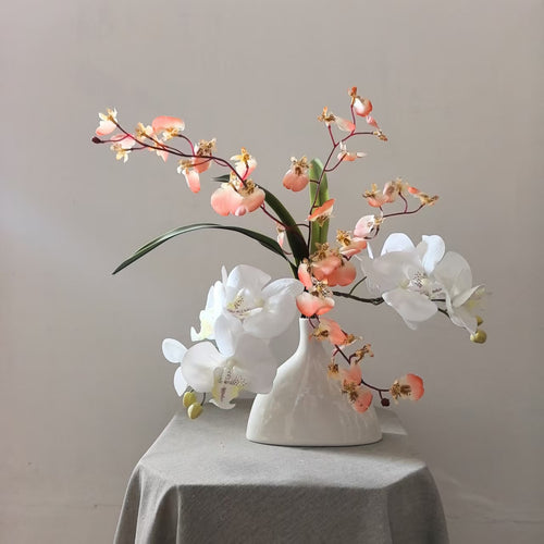 Lebensechte Orchideen Blumenarrangement