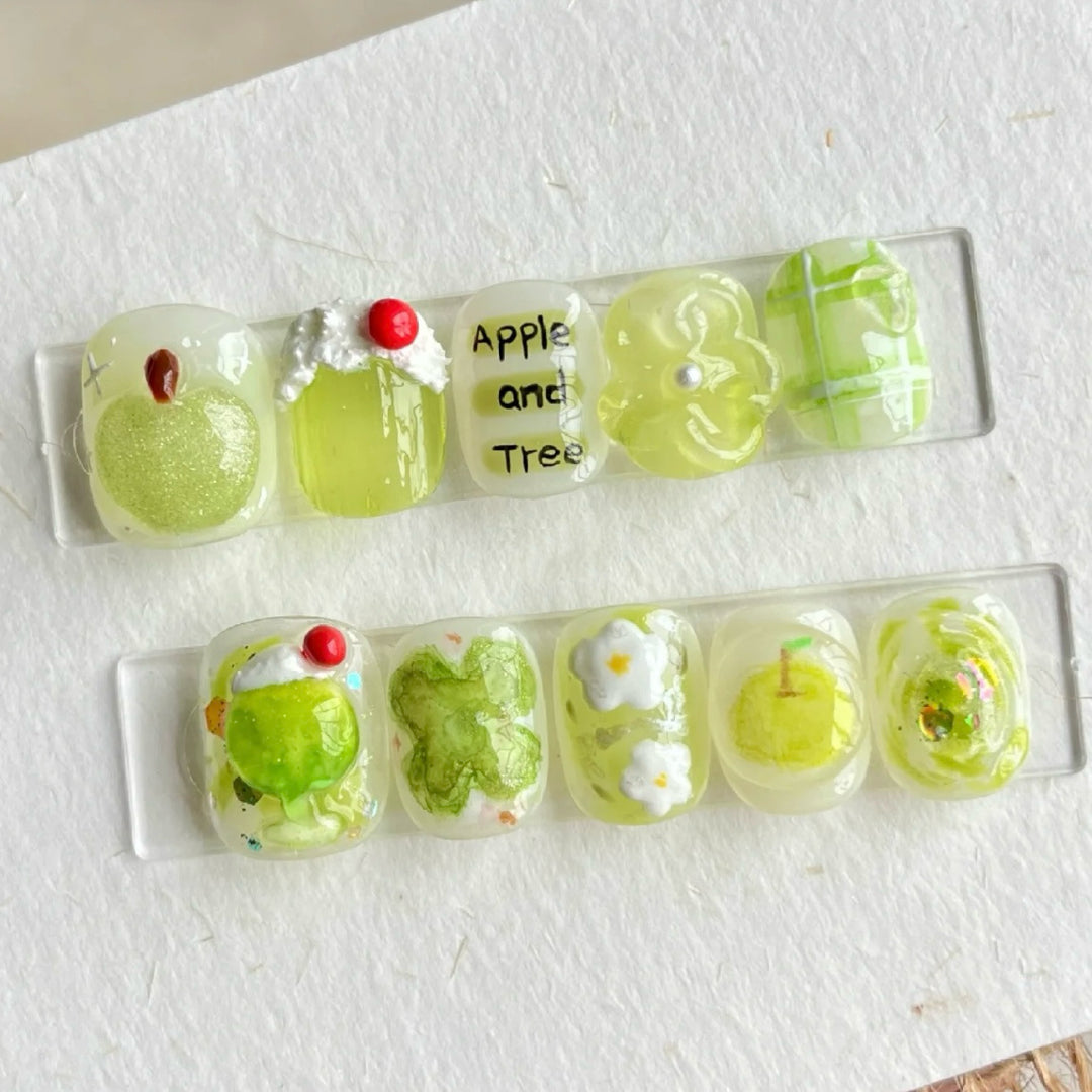 Künstlerisches Press-On Nageldesign Set mit Apfel- und Blumenmotiv