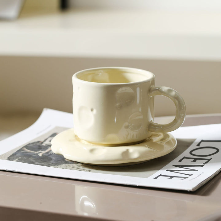 Skulpturales Keramikbecher-Set mit fließender Glasur und strukturierter Untertasse