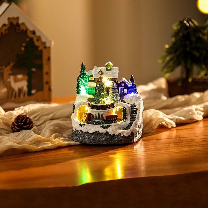 Beleuchtete Weihnachtsdorf-Szene mit Schneemann Karnz