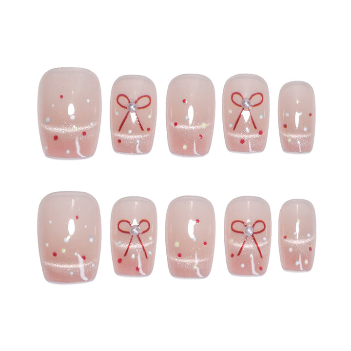 Künstliche Nagelkunst mit eleganten Schleifen und Glitzerakzenten Karnz