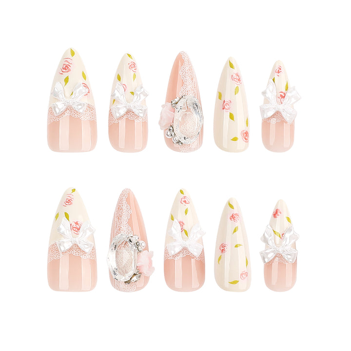 Kunstvolle Stiletto-Nägel mit floralen Akzenten und Glitzerakzenten Karnz