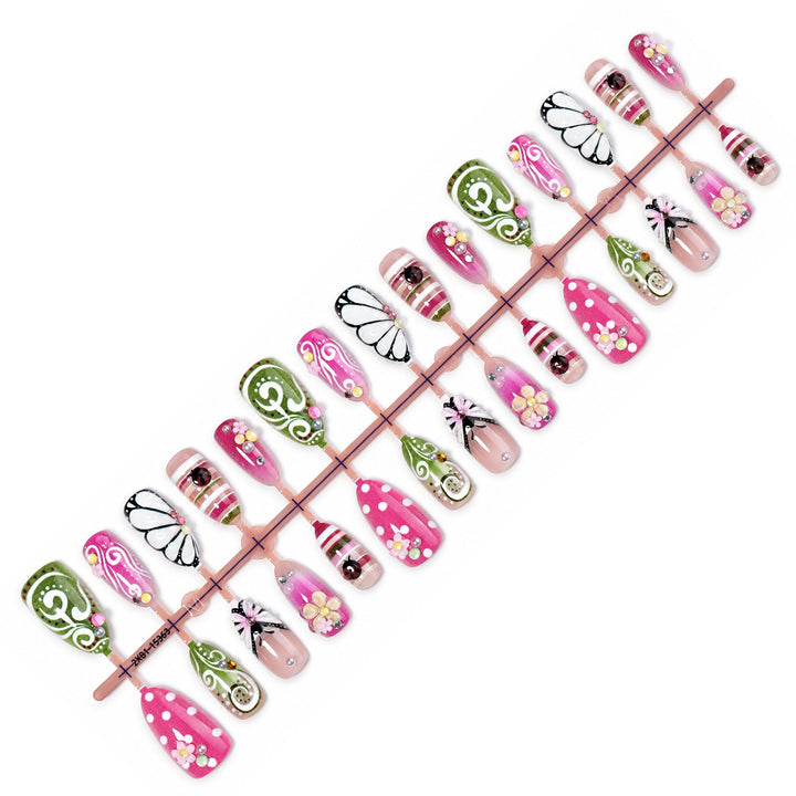 Kunstnagelset mit verspielten Blumen- und Glitzermotiven Karnz