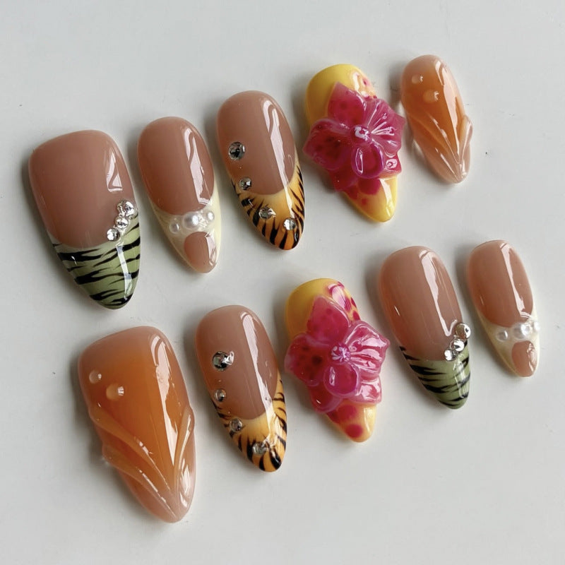 Kunstvolle Stiletto-Nägel mit buntem Blüten-Design und Glitzer Karnz