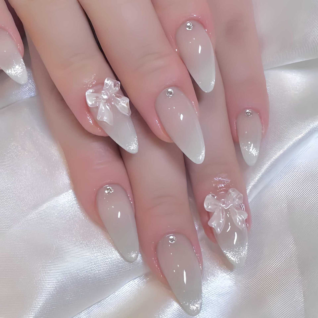 Elegante stilettoförmige Press-On Nägel mit dekorativen Schleifenakzenten Karnz
