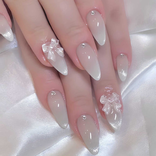 Elegante stilettoförmige Press-On Nägel mit dekorativen Schleifenakzenten Karnz