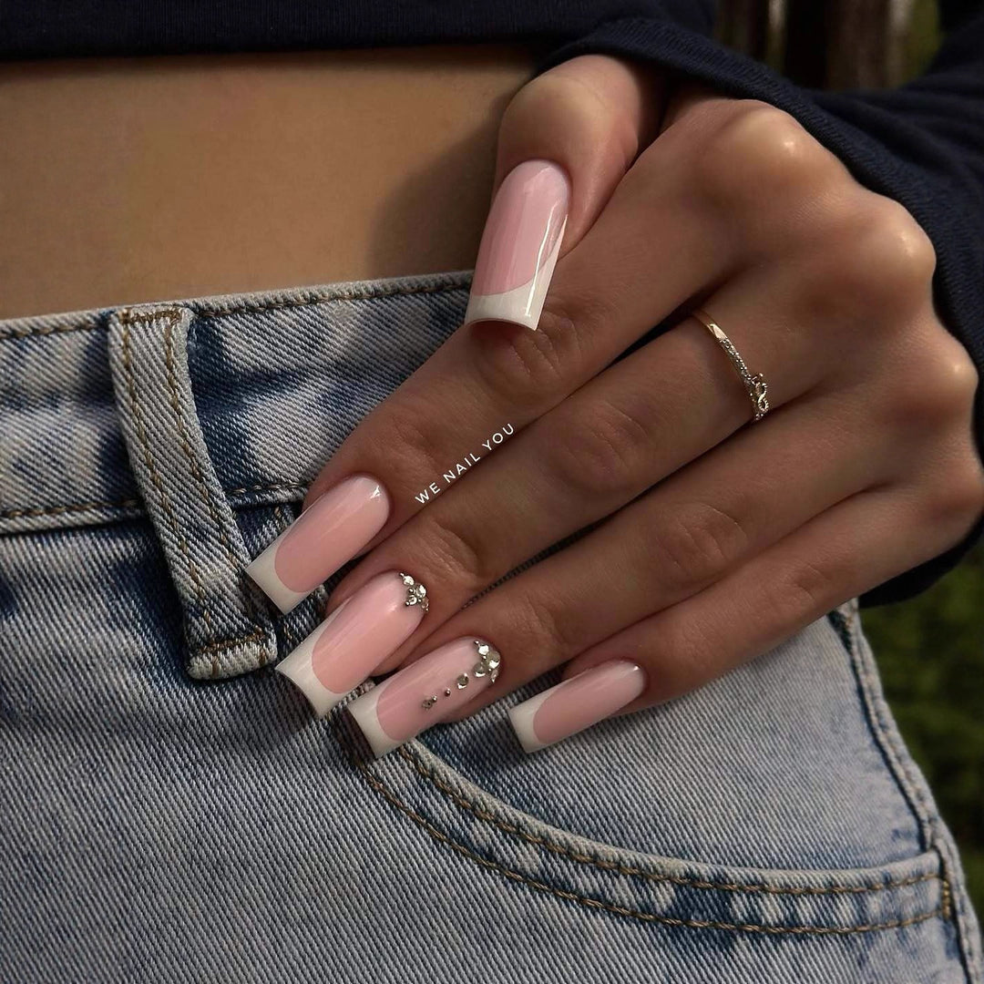 Kunstnagelset mit eleganten French Spitzen und funkelnden Strassakzenten Karnz