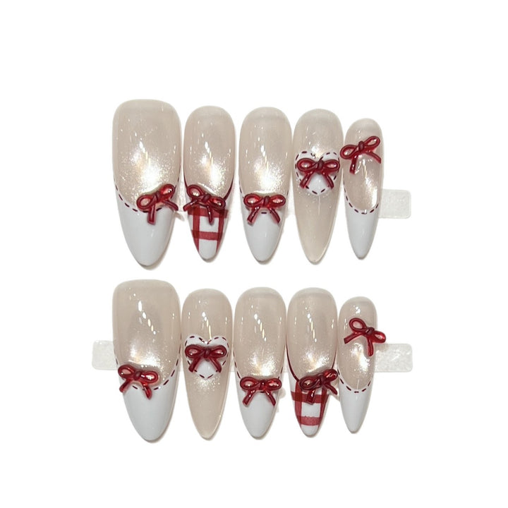 Dekorativer Stiletto Press-On Nagelset mit Schleifenakzenten Karnz