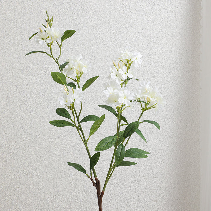 Dekorativer Kunstzweig mit weißen Blüten Karnz
