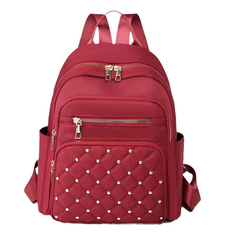 Quilted Rucksack mit dekorativen Nieten Karnz
