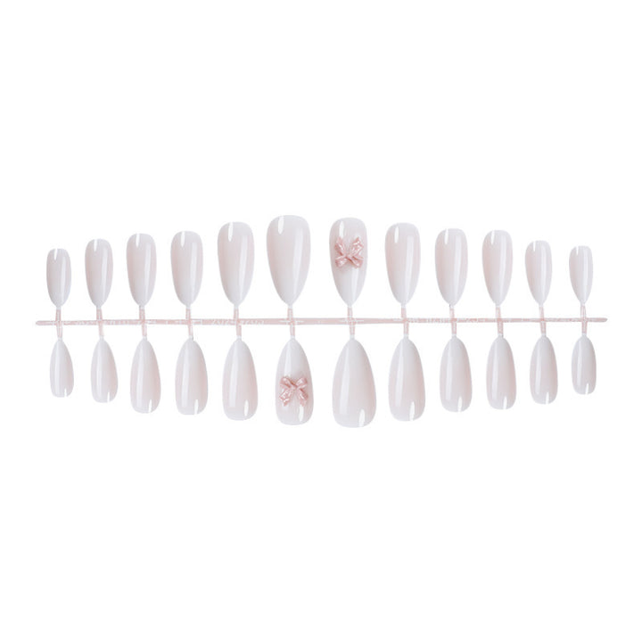 Elegantes Kunstnagelset mit luxuriösem Ombre-Effekt und zarten Schleifenakzenten Karnz