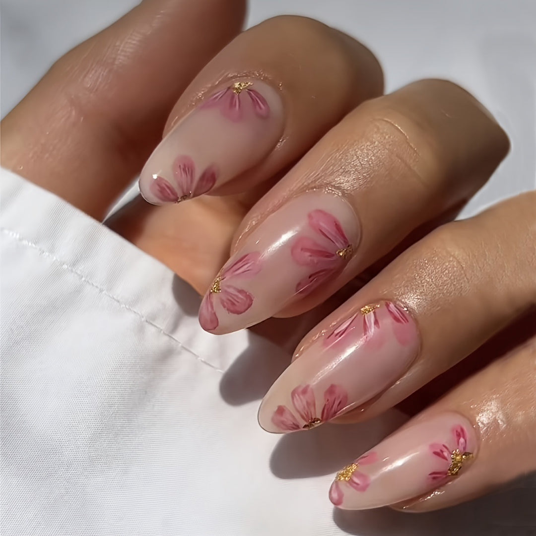 Kunstnagelset mit floralen Akzenten und Goldverzierungen Karnz