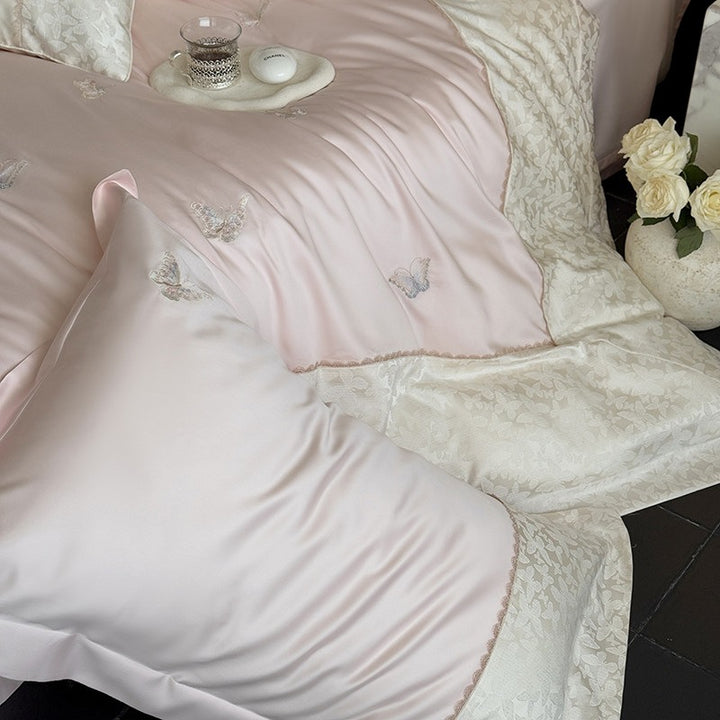 Luxuriöses Baumwollsatin-Bettwäscheset mit Schmetterlingsstickerei und Bindeband-Kissen