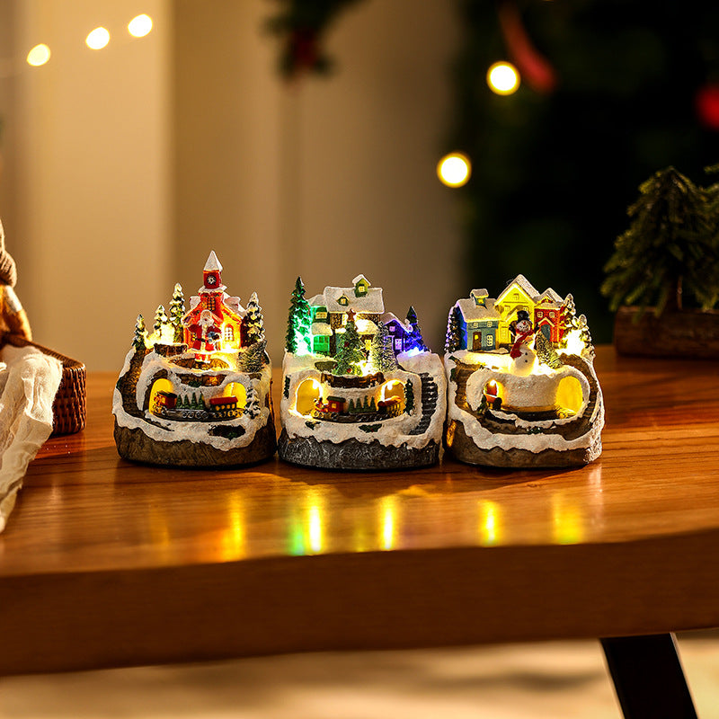Beleuchtete Weihnachtsdorf-Szene mit Schneemann Karnz