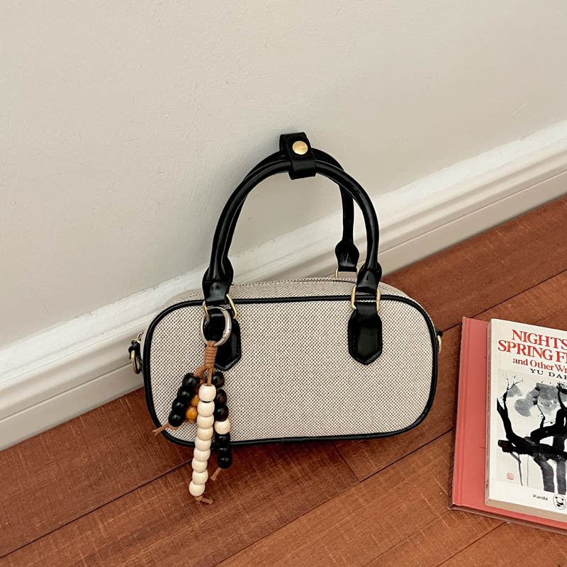 Vintage-inspirierte glänzende Handtasche