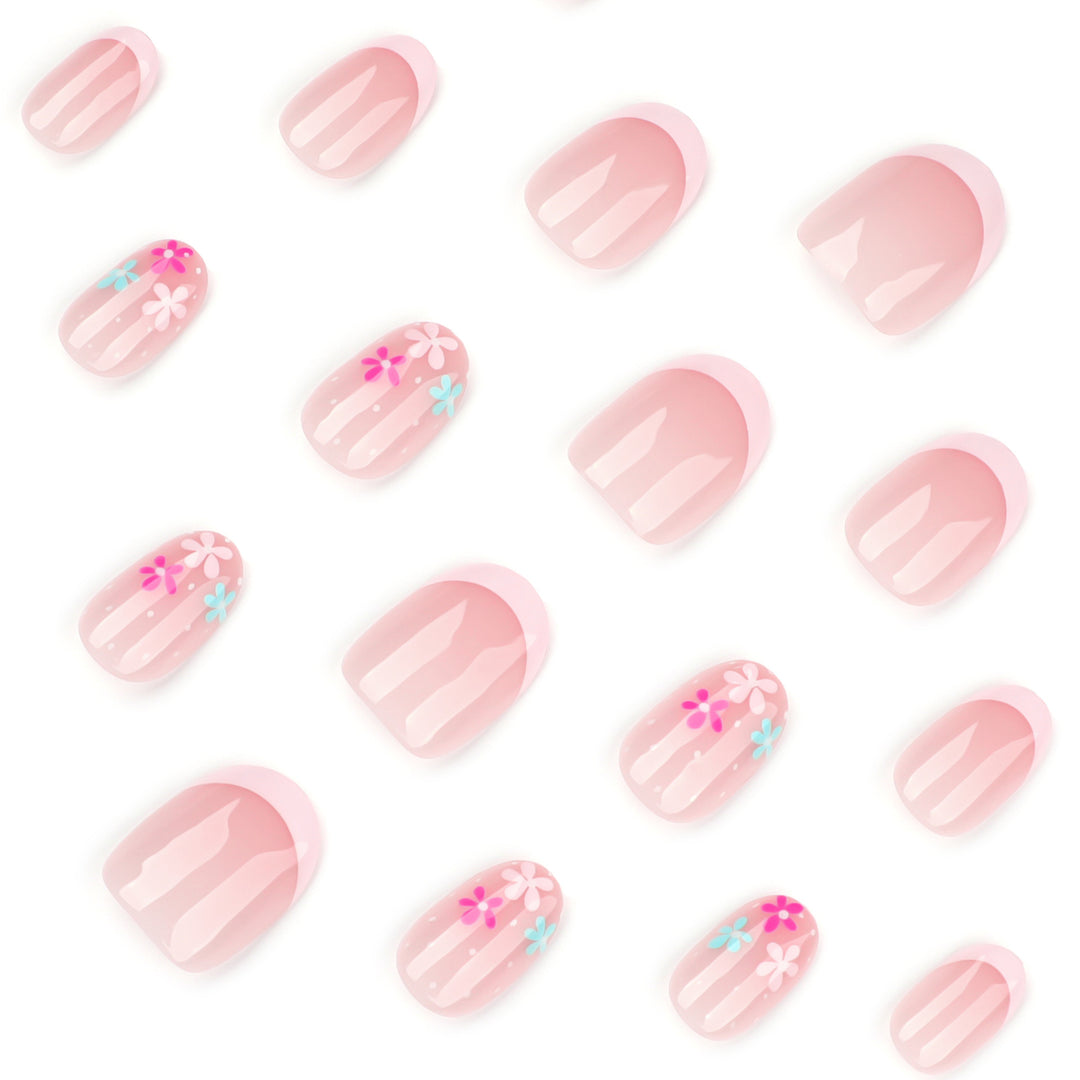 Kunstvolle Nagelverlängerungen mit bunten Blütenmotiven und Glitzer Karnz