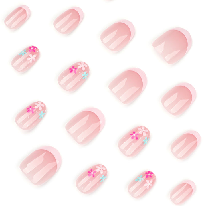 Kunstvolle Nagelverlängerungen mit bunten Blütenmotiven und Glitzer Karnz