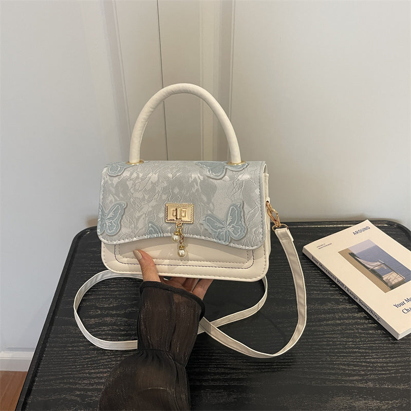 Elegante blumengemusterte Abendhandtasche
