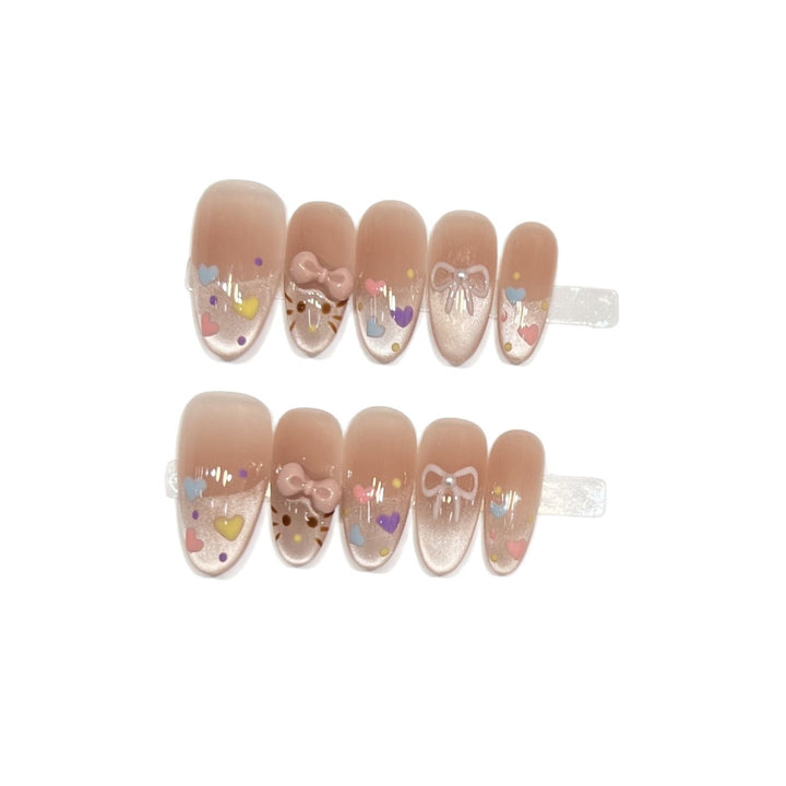 Dekorativer Press-On Nail Set mit bunten Herz- und Schleifendekoren Karnz