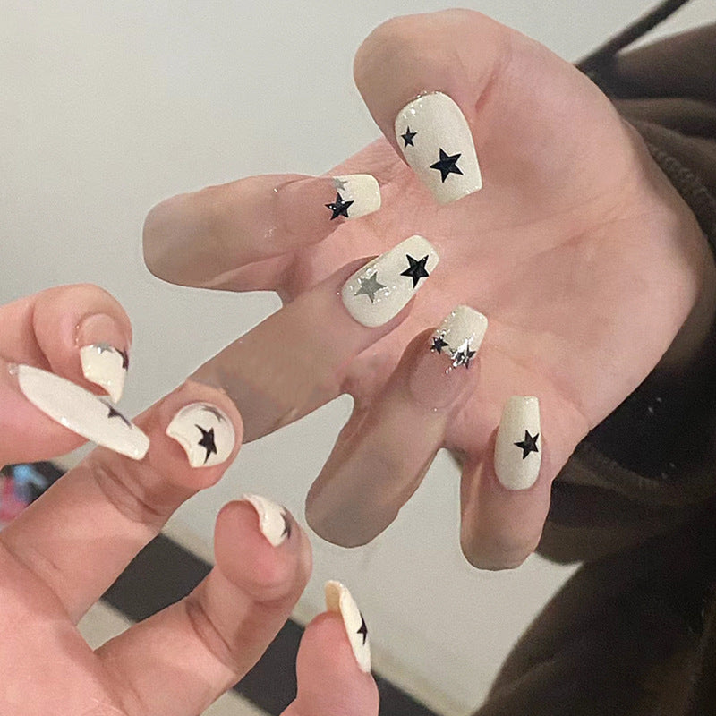 Kunstnagelset mit glamourösem Sternen-Design und funkelnden Akzenten Karnz
