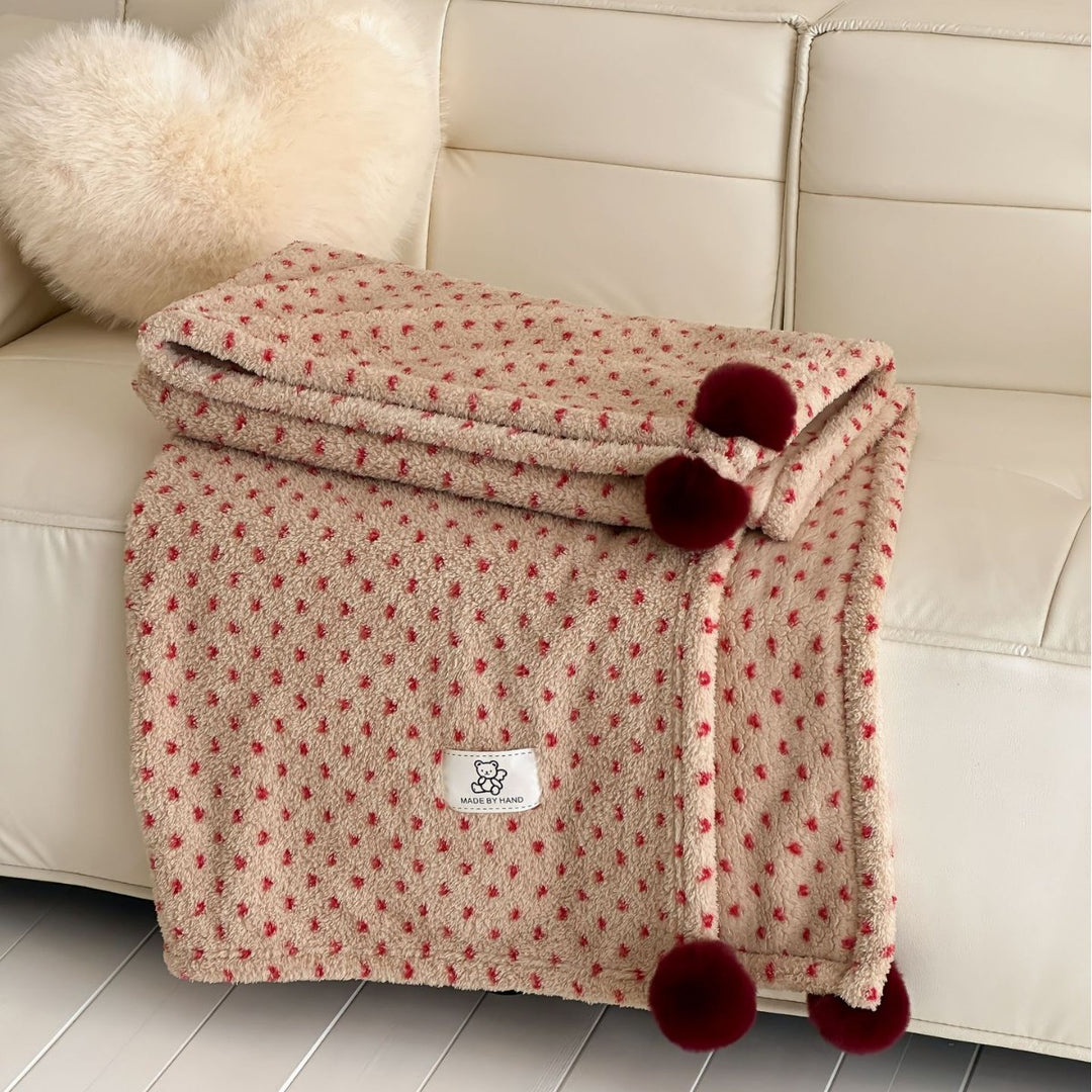 Große kuschelige Wohndecke im Nordic-Boho-Muster mit Pompon-Quasten