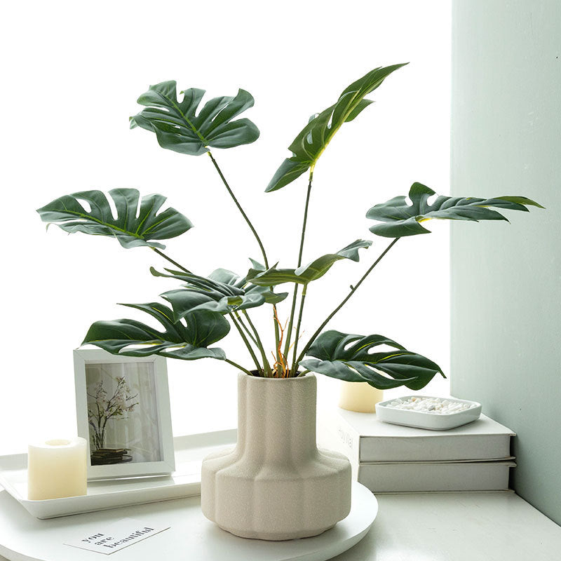 Dekorative Monstera Blatt Pflanzenanordnung für Zuhause