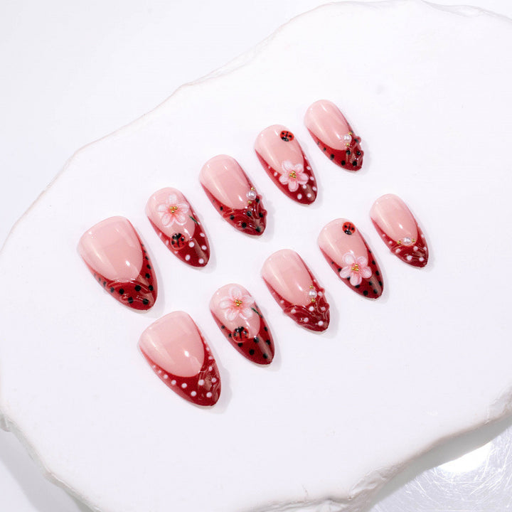 Künstlerisches Press-On-Nagelset mit floralem und Marienkäferdesign