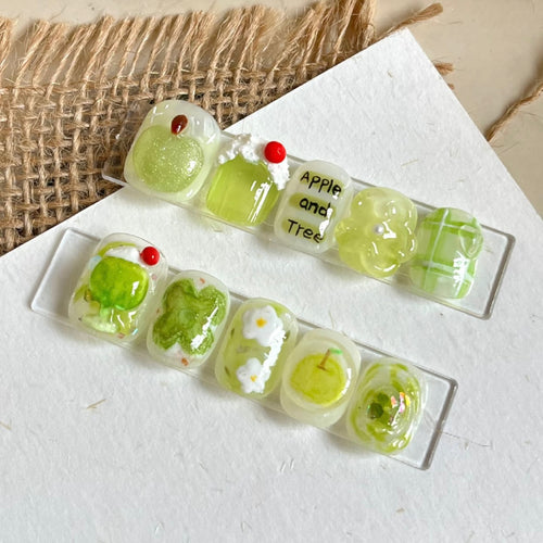 Künstlerisches Press-On Nageldesign Set mit Apfel- und Blumenmotiv