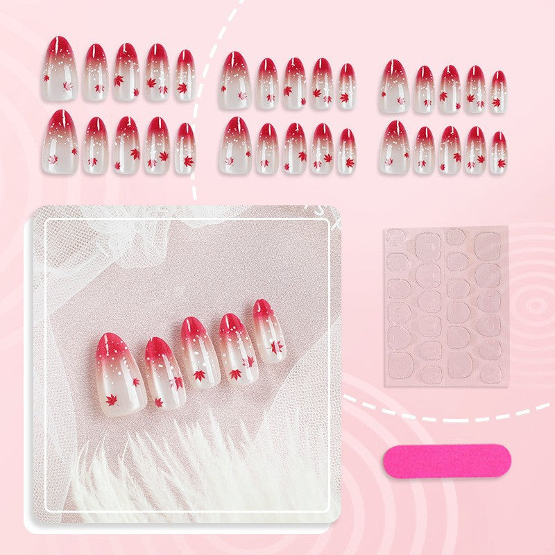Kunstnagelset mit elegantem Rot-Ombré-Look und zarten Ahornblättern Karnz