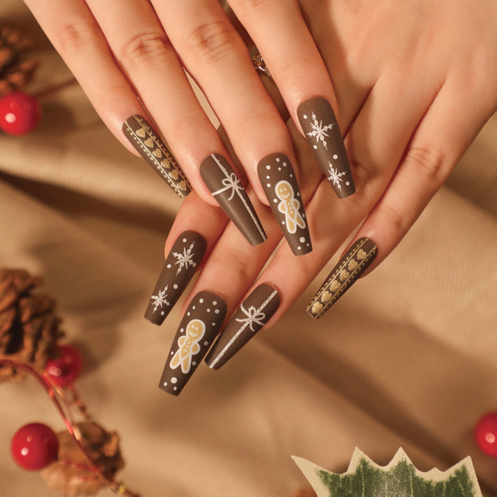 Künstliche Nagelkunst mit festlichem Lebkuchen-Design Karnz