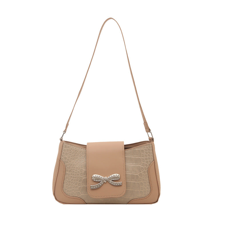 Elegante Handtasche mit Krokodilmuster und Schleifendetail