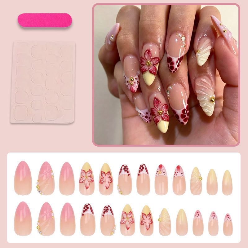 Kunstnagelset mit kreativen floralem Design und glitzernden Akzenten Karnz